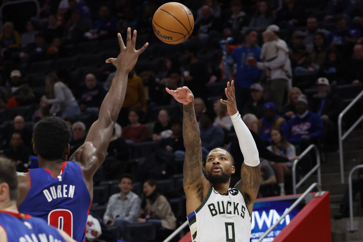 Milwaukee Bucks guard Damian Lillard (0) shoots on Detroit Pistons center Jalen Duren (0)